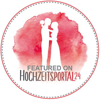 Silhouette of an embracing couple on a red watercolor background, with text "Featured on Hochzeitsportal24. Perfect inspiration for your special day in Zurich – whether you're looking for a wedding officiant or a wedding DJ.".